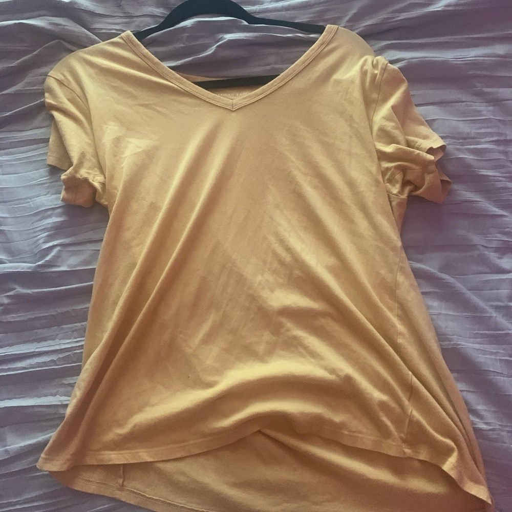 A light yellow short sleeve t shirt worn once